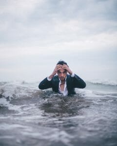 Man in a business suit in the ocean